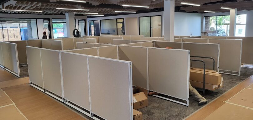 Modern office cubicles and workstations being installed in a Phoenix, Arizona office space, showcasing